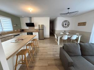 a kitchen and living room with a couch and a table at Dom & Val in Tournan-en-Brie