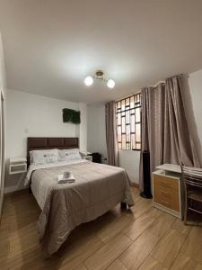 a bedroom with a large bed and a window at Hospedaje Ariana in Supe