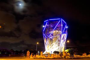 a clock tower lit up in blue at night at Anping Stay in Tainan