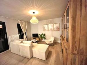 a living room with a white couch and a table at Casa Loua in Blankenberge