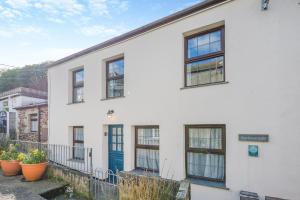 a white house with windows and a blue door at 3 Bed in Padstow oc-h28928 in Padstow