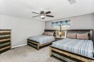 a bedroom with two beds and a ceiling fan at 1973 Salamanca St in Navarre +30 photos