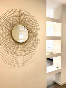 a mirror hanging on a wall in a room at The Twins Suite & Hub in Monza