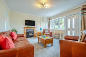a living room with two brown couches and a fireplace at 3 Bed in St. Merryn oc-p00114 in Saint Merryn