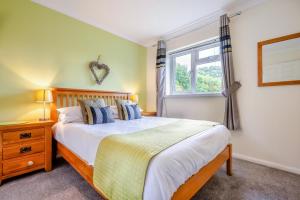 a bedroom with a large bed and a window at 3 Bed in St. Merryn oc-p00114 in Saint Merryn