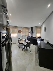 a kitchen with a table and a refrigerator in it at Noble Suite Luxury in Tangier +17 photos