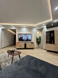 a living room with a large flat screen tv at Noble Suite Luxury in Tangier
