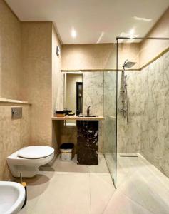 a bathroom with a shower and a toilet and a sink at Noble Suite Luxury in Tangier