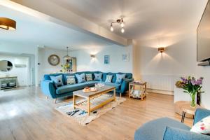 a living room with a blue couch and a table at 3 Bed in Padstow oc-p00793 in Padstow