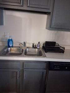 a kitchen counter with two sinks and a stove at Modern Space Great For Extended Stays Pool & Gym in Burnside East +16 photos