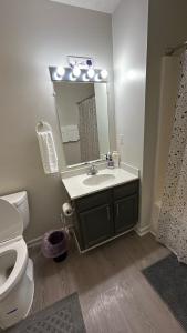 a bathroom with a sink and a toilet and a mirror at Modern Space Great For Extended Stays Pool & Gym in Burnside East