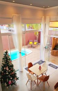 a christmas tree in the living room of a house with a christmas tree at Pousada Solari in São Francisco do Sul +45 photos
