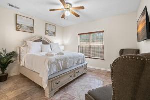 ein Schlafzimmer mit Bett und Deckenventilator in der Unterkunft Cozy 4B 2 5B University Home King Beds Jacuzzi in Charlotte
