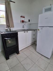 eine Küche mit Herd und Kühlschrank in der Unterkunft Casita de Campo - Chacra Lavanda in Salto