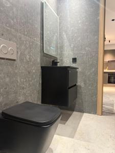 een badkamer met een zwart toilet en een spiegel bij Studio luxe Centre ville in Casablanca