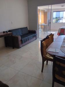 a living room with a couch and a table at Regina in Cabo Frio