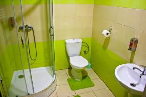 a bathroom with a shower and a toilet and a sink at Motel Görföl in Veľký Meder