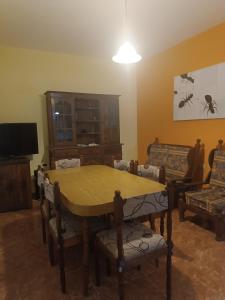 een woonkamer met een houten tafel en stoelen bij Palermo calle 1 in Mar del Tuyú