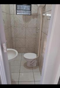 a bathroom with a toilet and a sink at Casa indisponíve in Maracaju +1 photo