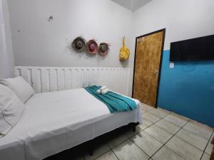 a bedroom with a bed and a door with a towel on it at Mini Hostel in Tutóia +78 photos