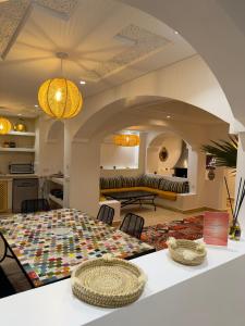 a kitchen and living room with a table and a couch at Riad Marhaba in Marrakesh