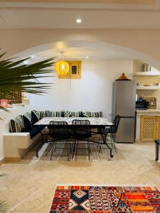 a dining room with a table and a couch at Riad Marhaba in Marrakesh +36 photos