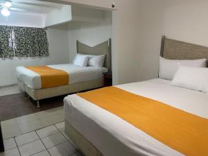 a hotel room with two beds in a room at Hotel La Sexta in Tijuana