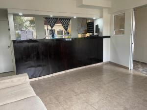 a bar with a black counter in a room at Hotel La Sexta in Tijuana