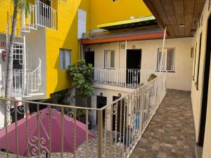 a balcony of a building with yellow and white at Hotel La Sexta in Tijuana