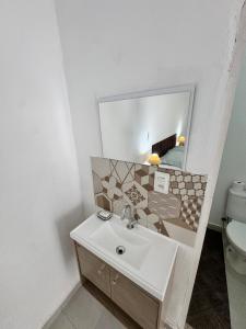 a bathroom with a sink and a mirror at Suite 1 com Ar-Condicionado, TV, Wi-Fi e Geladeira in Jundiaí