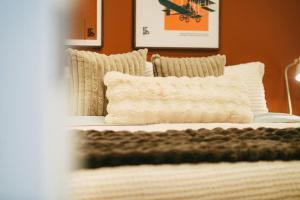 a bed with white sheets and pillows in a room at Historic 2BR suite in Halifax w Free Parking in Halifax