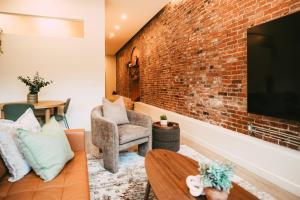 a living room with a brick wall at Historic 2BR suite in Halifax w Free Parking in Halifax