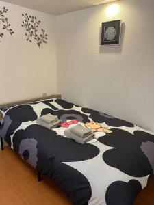 a bed in a room with a cow print at 202basichostel in Osaka