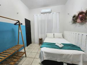 a bedroom with a bed and a staircase in it at Mini Hostel in Tutóia
