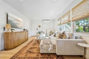 a living room with a couch and a large window at Casa Yano by The Beach in Santa Barbara