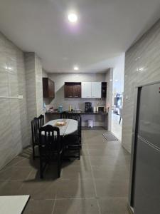 a kitchen and dining room with a table and chairs at Teeview Homes 9A in Tanah Rata