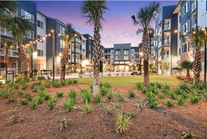 an exterior view of a resort with palm trees at Landing Modern 3BD Gym Rooftop Lounge in Bellview