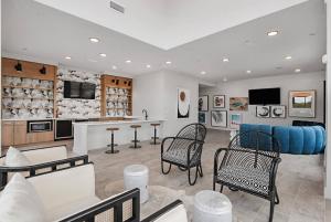 a living room with a couch and a table and chairs at Landing Modern 3BD Gym Rooftop Lounge in Bellview