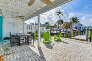 a patio with a table and chairs on a patio at Near Beaches Waterfront Gem in Anna Maria Island! in Anna Maria Island