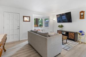 a living room with a couch and a tv at Seattle cottage in Seattle