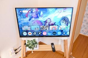 a flat screen tv sitting on top of a stand at 民泊 Ichinomiya K Room 2B in Ichinomiya