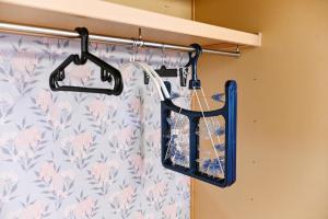 a closet with two hangers and a shower curtain at 民泊 Ichinomiya K Room 2B in Ichinomiya