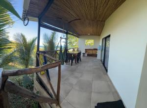 an open hallway with a dining room and a table at Surf Lodge El Carrizal-Punta Mango in La Periquera +43 photos