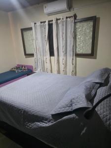 a bedroom with a bed and a window at Mirador del Diablo in Punta Del Diablo
