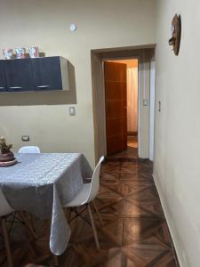 a dining room with a table and white chairs at Alojamiento Del Valle in San Fernando del Valle de Catamarca +8 photos