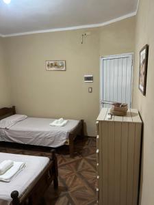 a room with two beds and a radiator in it at Alojamiento Del Valle in San Fernando del Valle de Catamarca