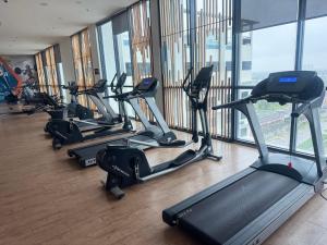 a row of exercise bikes in a gym with windows at Nasai Retreat Studio in H Elite Design Building in Kota Bharu