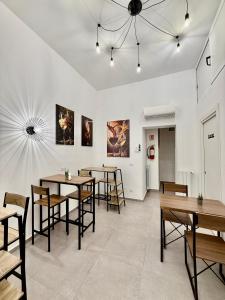 a dining room with wooden tables and chairs at Foresteria del Genio - Luxury Suites & Urban Spa in Palermo