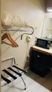 a hospital bed with a microwave on a desk at Rodeway Inn Jackson in Jackson