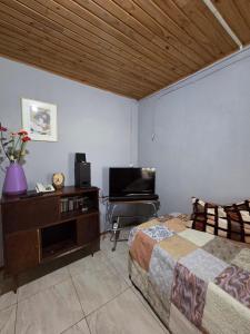 a bedroom with a bed and a television in it at Nido Rústico in Rivera